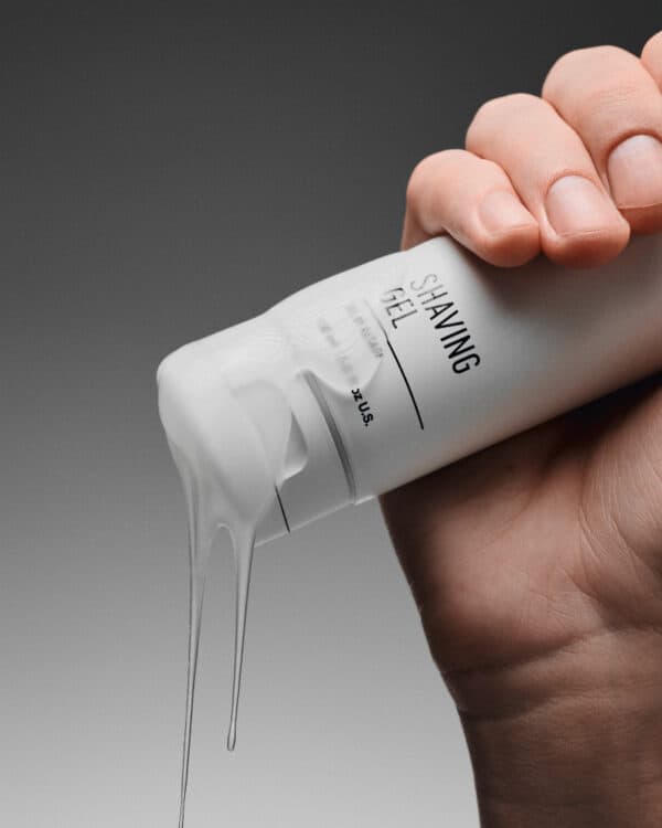 Hand houdt scheermousse van Finesse Beauty, ideaal voor gladde scheerbeurten. Shaving Gel STMNT