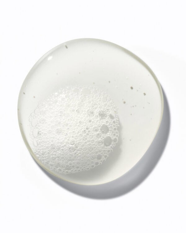 Hydrate shampoo in a white bowl with foam, for healthy hair care.